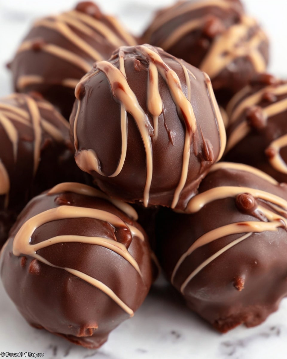 A close-up view of several round chocolate truffles piled together, each covered in a smooth, dark chocolate shell with irregular drizzles of lighter milk chocolate on top. The truffles have a shiny, glossy surface with the milk chocolate forming thin, flowing lines and small blobs that add texture and contrast. The background is a white marbled texture that softly highlights the rich brown colors of the chocolates. photo taken with an iphone --ar 4:5 --v 7
